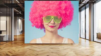 Portrait of beautiful woman in pink wig and green glasses Wall mural