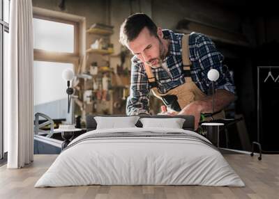 Carpenter working on woodworking in carpentry workshop Wall mural