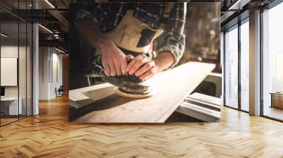 Close up of sanding a wood with orbital sander at workshop Wall mural