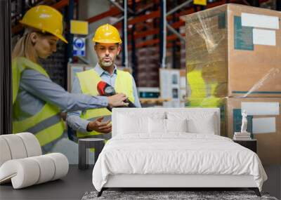 Female warehouse worker learns how to use forklift with instructor Wall mural