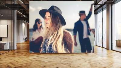 Group of friends dancing and celebrating on beach, boho party Wall mural