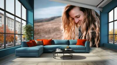 Happy young woman with long hair lifestyle portrait outdoor Wall mural