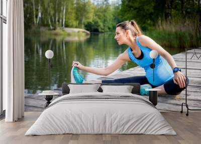 Pregnancy exercise, pregnant woman stretching outdoor Wall mural