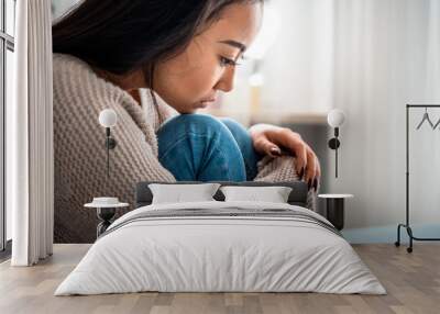 Sad lonely depressed asian woman on sofa at home Wall mural