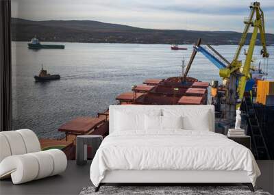 A manipulator crane in the seaport is used for unloading wagons and loading bulk cargo into the holds of sea ships. Wall mural