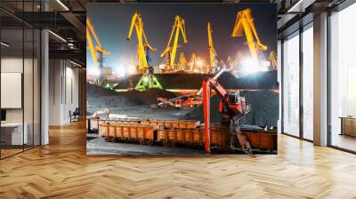 Coal terminal at the seaport at night.
Mountains of coal, Belt conveyors, Portal and hydraulic cranes, industrial wagons. Wall mural