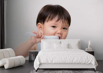 Asian Baby eat with a spoon Wall mural