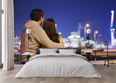 Couple looking at tourist attraction view in Hong Kong at night Wall mural