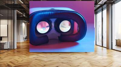 Holding virtual reality device with pink and blue light Wall mural