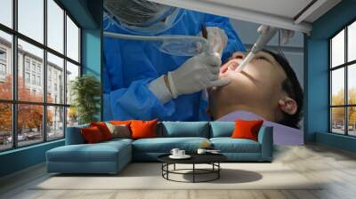 Man undergo the dental treatment in clinic Wall mural