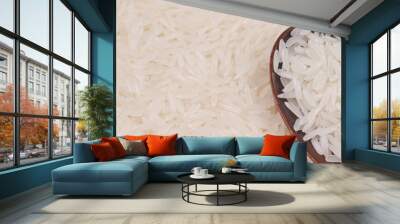 Uncooked white rice and wooden spoon Wall mural