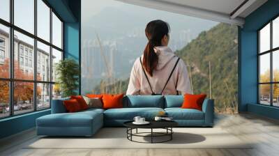 Woman enjoy the scenery view on mountain Wall mural