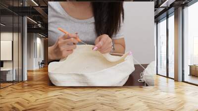 Woman knitter making fabric from thread Wall mural