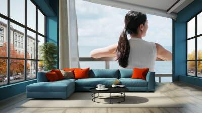 Woman look at the sea view at balcony Wall mural