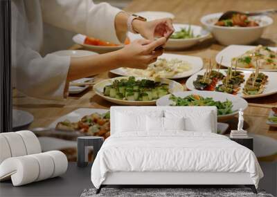 Woman take photo on her dinner at home Wall mural