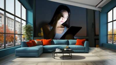 Young Woman feeling eye pain when using tablet pc at night Wall mural