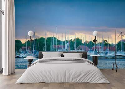 Boats in the harbor of Mikolajki at sunset Wall mural