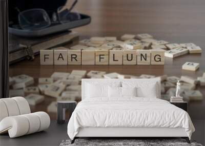 far flung word or concept represented by wooden letter tiles on a wooden table with glasses and a book Wall mural