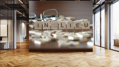 in lieu word or concept represented by wooden letter tiles on a wooden table with glasses and a book Wall mural