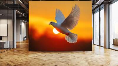 A white dove flies against a vibrant orange sunset, its wings outstretched and feathers catching the light. Wall mural