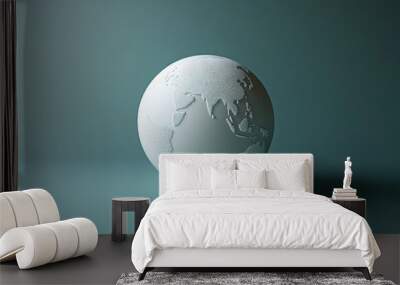 A white globe with continents embossed on it sits on a teal background, casting a shadow. Wall mural