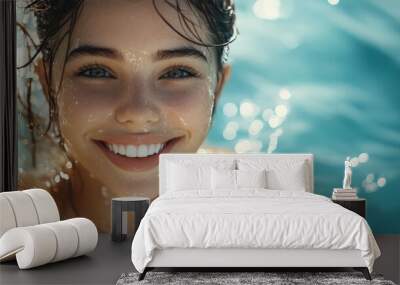 Close-up portrait of a young woman with wet hair smiling in a swimming pool. Wall mural