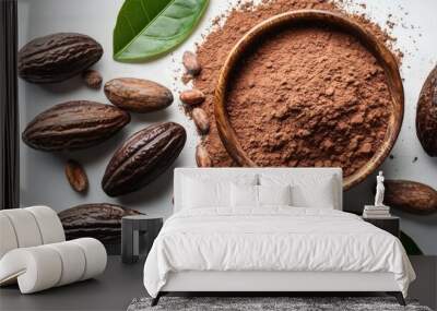 Cocoa powder in bowl with cocoa beans and leaves. Wall mural