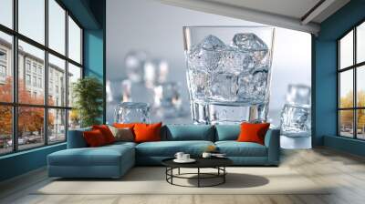 Glass of water with ice cubes on a white background. Wall mural