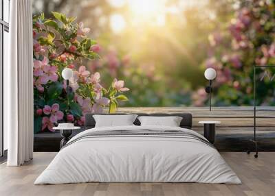 Wooden table with pink flowers and sunbeams in the background. Wall mural