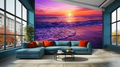 Captivating image of a majestic sunset over a serene beach, with vibrant purple and pink hues reflecting on the ocean's surface. Wall mural