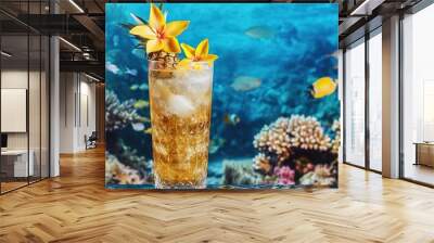 A tall glass filled with a golden-hued tropical cocktail, beautifully adorned with yellow hibiscus flowers and a star-shaped slice of pineapple, set against a vibrant coral reef bustling  Wall mural