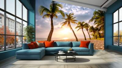 Coconut palm trees against colorful sunset Wall mural