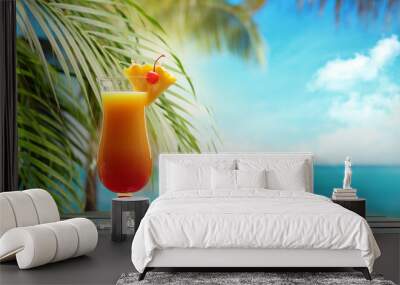 refreshing orange cocktail on beach table. Wall mural