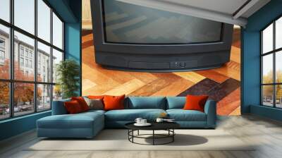 Vintage Television stands on a wooden parquet floor, old design in the house. Wall mural