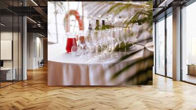 blurry champagne glasses  and bottles on wedding banquet table. Wall mural