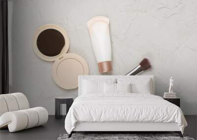 Composition with makeup products for skin tone on concrete background, top view Wall mural