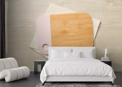 Cutting board with towel on wooden background, top view Wall mural