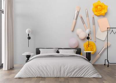 Makeup brushes and sponges on color background, top view Wall mural