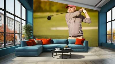 Male golf player teeing off with club. Wall mural