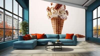 A scoop of ice cream in a waffle cone with nuts on top Wall mural