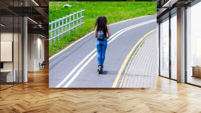  Girl rides an electric scooter in the summer Park
 Wall mural