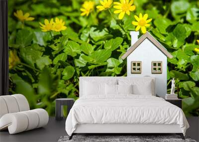 The symbol of the house stands among the yellow flowers
 Wall mural