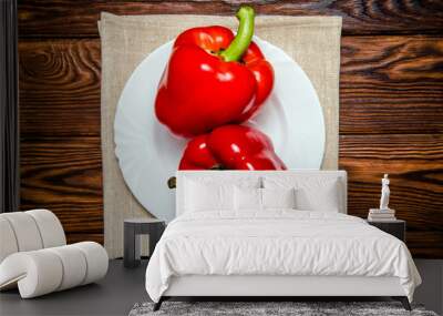 Two red peppers lying on a linen tablecloth  Wall mural