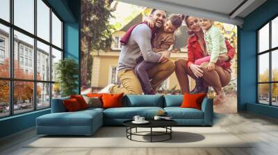 Happy family outside in colorful fall backyard poses to camera. Wall mural