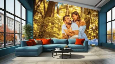 Portrait of young happy couple in nature. Wall mural