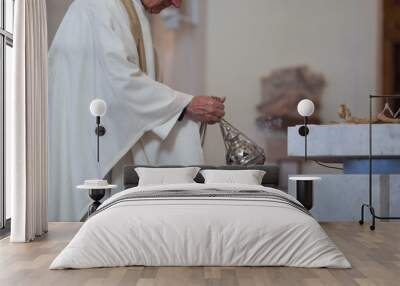 The priest of the Roman Catholic Church censers censer during the Holy Mass in the church. Feast of the Body of the Lord Wall mural