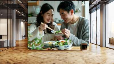 A japanese couple happily enjoying a meal together at home, white clean modern living room Wall mural