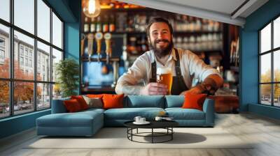 Portrait of a happy barman serving beer at the counter of a bar Wall mural