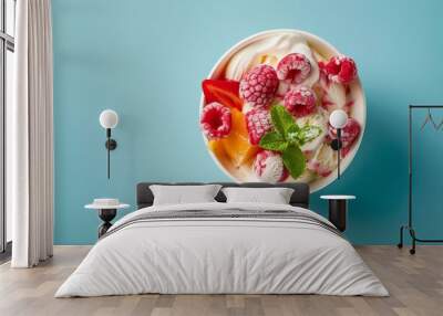 Top view of a bowl of ice cream balls with fruits in blue background Wall mural