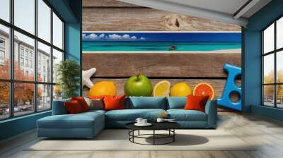 A unique and eye-catching image of a beach boarder, adorned with colorful elements such as exotic fruits and a beach ball, set against a rustic wood texture Wall mural